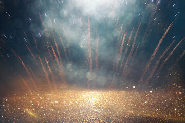 background of abstract gold, black and blue glitter lights with fireworks. defocused