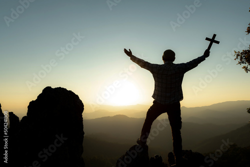 Easter Sunday concept: Silhouette scars in hands of Jesus Christ on sunrise background