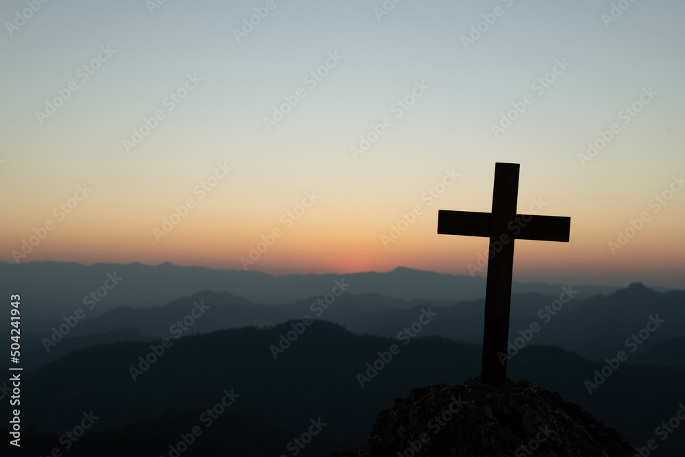 cross crucifixion of the crucifixion of jesus christ on a mountain with a sunset background