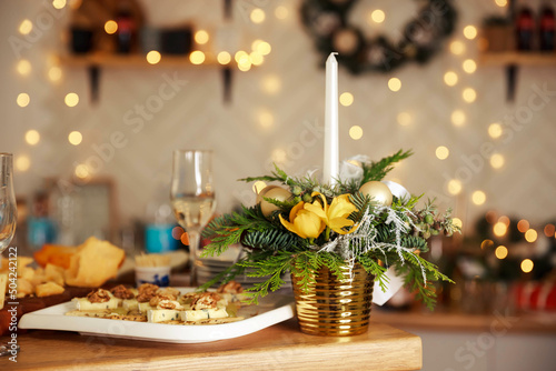 Cozy evening for valentine's day or Christmas celebration concept. Candlelight dinner table setup for couple with beautiful light as background. Enjoying a romantic candlelight dinner together.