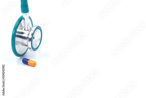 Pill or medication next to a doctor's stethoscope. Concept of health care