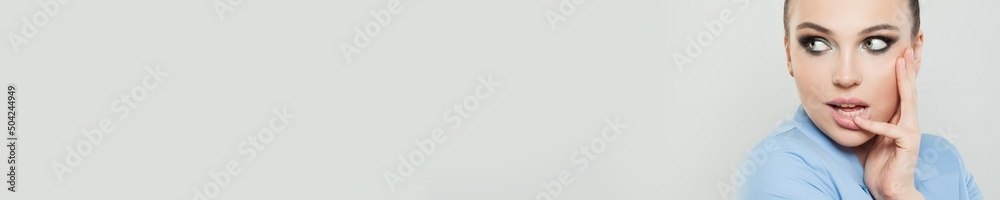 Cute young model woman face closeup portrait on grey banner background Cute young model woman face closeup portrait on grey banner background