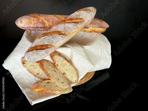 French baguette isolated on black background, traditional fresh bread for  meal  