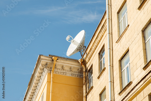 Fotografering Large satellite dish or satellite antenna on building roof