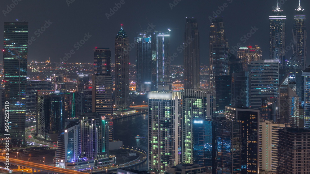 Skyline with modern architecture of Dubai business bay towers night timelapse. Aerial view