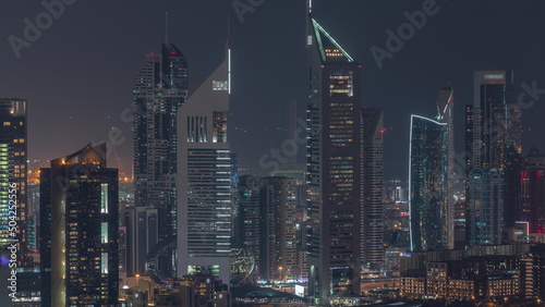Rows of skyscrapers in financial district of Dubai aerial night timelapse.