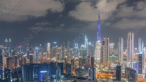 Panoramic skyline of Dubai with business bay and downtown district night timelapse.