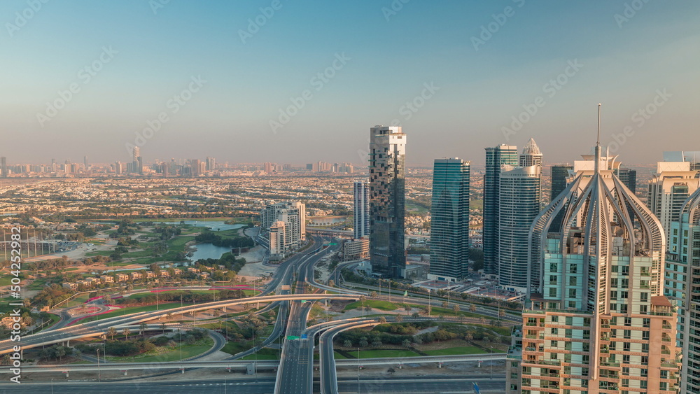 Obraz premium Huge highway crossroad junction between JLT district and Dubai Marina intersected by Sheikh Zayed Road aerial timelapse.
