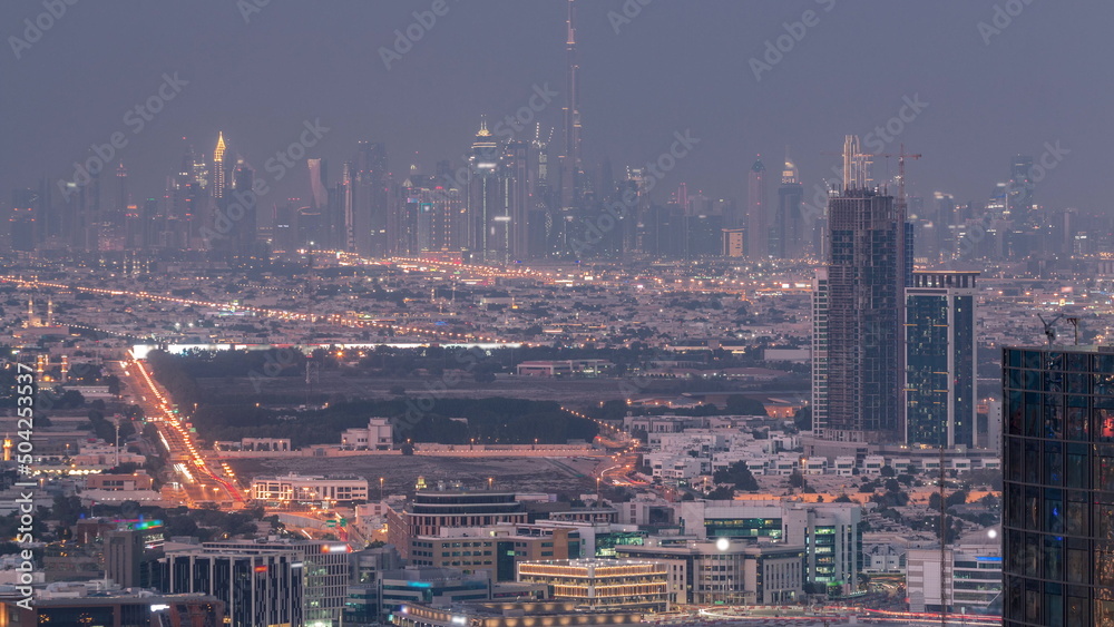 Dubai Downtown skyline row of skyscrapers with tallset tower aerial day to night timelapse. UAE