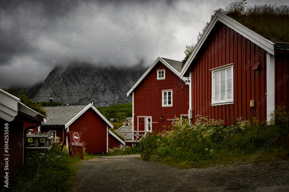 Red, fishing houses in Reine at dark and cloudy day, Lofoten archipelago in Norway