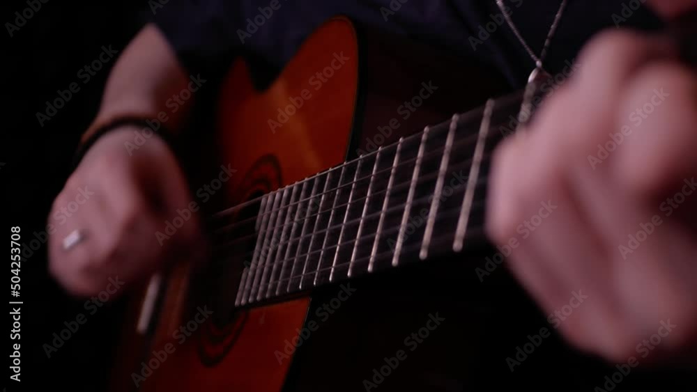 man plays guitar, closeup, indoors. concept of talent, hobby, professional musician in recording studio performs song. Live music on air. stylish man plays guitar, closeup, indoors. concept of talent, hobby, professional musician in recording studio performs song. Live music on air. stylish