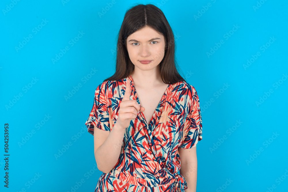 young caucasian woman wearing floral dress over blue background frustrated and pointing to the front young caucasian woman wearing floral dress over blue background frustrated and pointing to the front