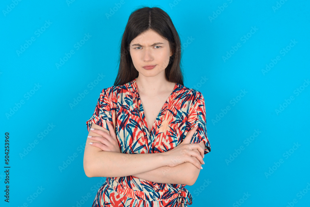 young caucasian woman wearing floral dress over blue background Pointing down with fingers showing advertisement, surprised face and open mouth young caucasian woman wearing floral dress over blue background Pointing down with fingers showing advertisement, surprised face and open mouth