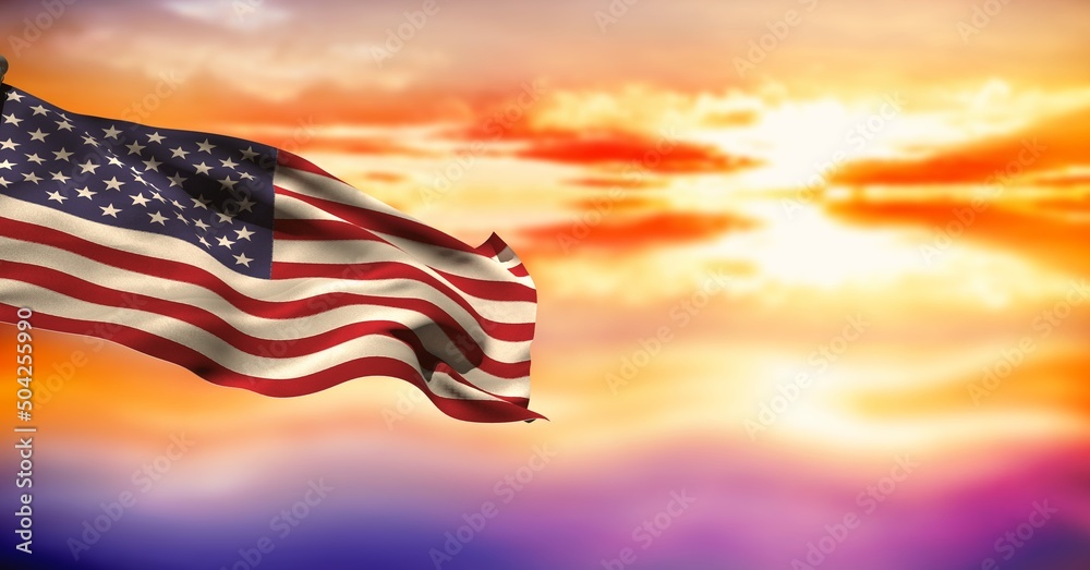 Fototapeta premium Composite image of waving american flag against sunset sky in background