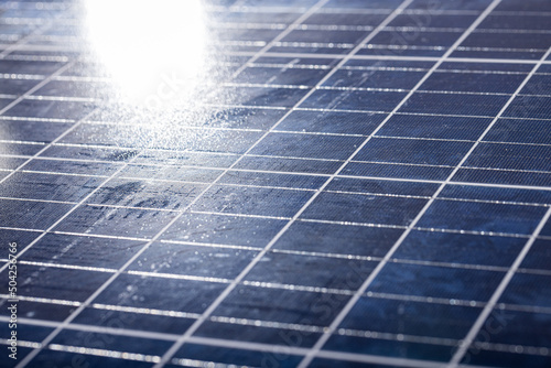 High angle close-up of sunlight falling on solar panel with white grid pattern, copy space