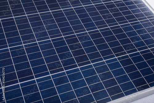 High angle close-up of blue solar panel with white grid pattern, copy space