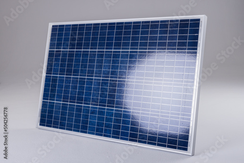 Sunlight reflecting on blue solar panel isolated against white background, copy space