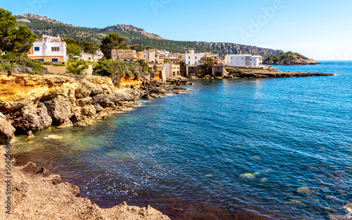 Mallorca island, beach in Sant Elm. Seashore, azure sea and buildings