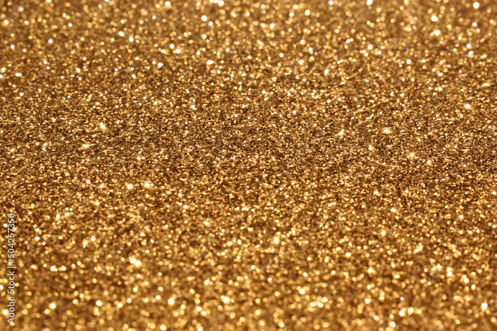 Golden bokeh glitter texture background. Photo can be used for the concept of Christmas, New Year and all celebrations backgrounds. 
