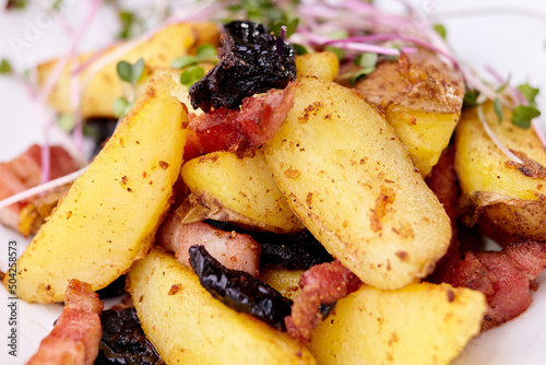 baked potatoes, baked potato dish with microgreens on a white plate close up