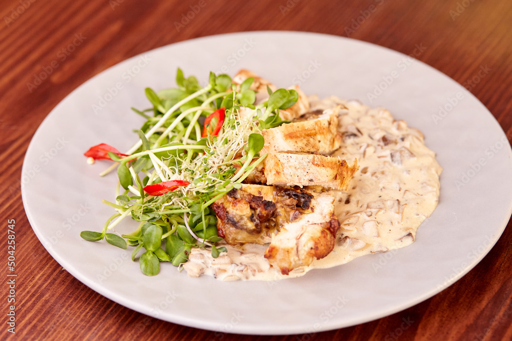 pieces of chicken roll with sauce and microgreens pieces of chicken roll with sauce and microgreens