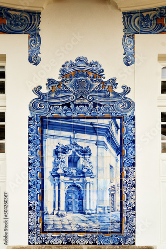 detail of a panel of azulejos tiles showing a church on the facade of old railways station in Aveiro, Portugal