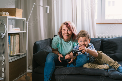 mother and son playing video gamer at home