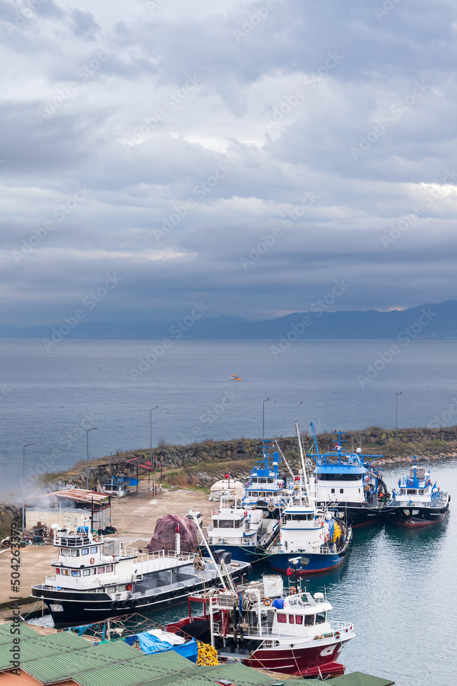 Fleet of fishing boats moored in harbor of Arakli, Trabzon, Turkey
