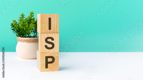 isp - word from wooden blocks with letters, green background. copy space available photo