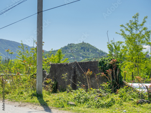 Remains of an old fence against the backdrop of a mountain. Beautiful place. Abandoned in nature. photo