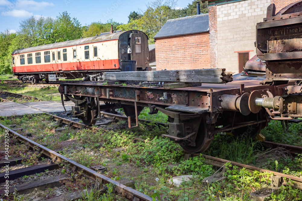 Naklejka premium old and abandoned railway carriages and rail industry equipment in a disused railway yard