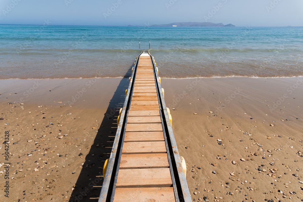 Safe motorized wheelchair ramp, used to transport disabled people into the sea water for swimming. Heraklion, Crete, Greece Safe motorized wheelchair ramp, used to transport disabled people into the sea water for swimming. Heraklion, Crete, Greece