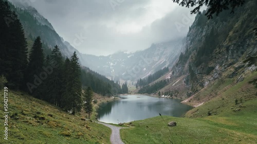 Gorgeous Timelapse on a rainy day on a tiny alpine lake in Switzerland, panorama