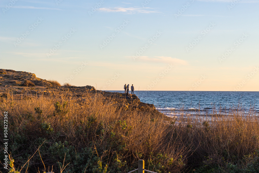 Boys watching the Mediterranean sea at the coast