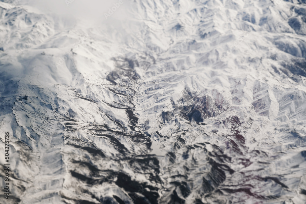 Aerial view of snowy mountains with clouds Aerial view of snowy mountains with clouds