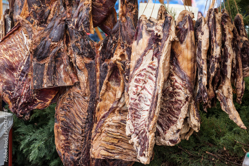 Selective blur on blocks of pork meat, dried cured pork, smoked, hung on a stand in the countryside of serbia. Also called suvomeso, it's a traditional meat product from balkans... photo