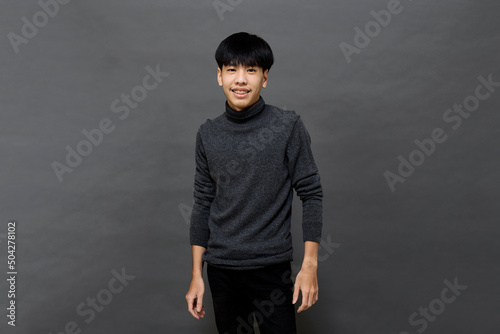 Young handsome Asian man posing at studio