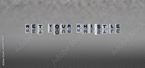 wet your whistle word or concept represented by black and white letter cubes on a grey horizon background stretching to infinity photo