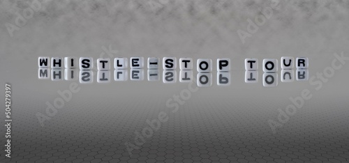 whistle stop tour word or concept represented by black and white letter cubes on a grey horizon background stretching to infinity photo