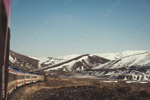 Eastern express train and snowy hills in winter season. photo