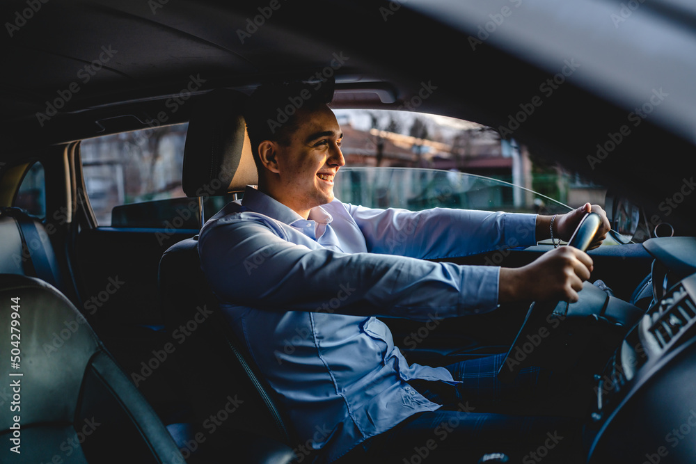 One man drive car young adult businessman smiling happy male person wearing blue shirt going to work alone in sunny day real people copy space - obrazy, fototapety, plakaty 