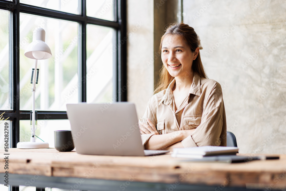 Asian businesswoman or accountant working on calculator to calculate business data, accounting document, and laptop computer at home office, business concept
