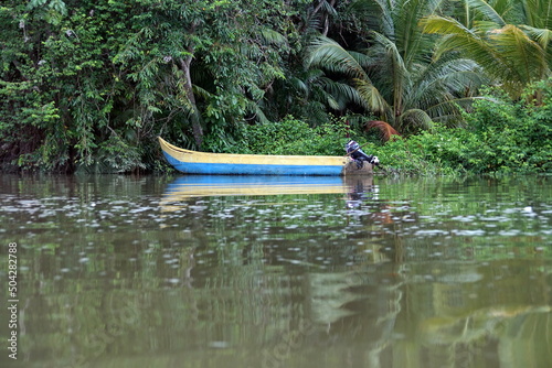 Boat moored on the bank of a river in the wetland outside of San Lorenzo, Ecuador