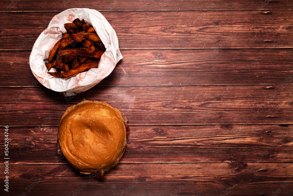 Hamburger with speck, cheese, vegetables and sauce. Beef burger. Selective focus with shallow depth of field Hamburger with speck, cheese, vegetables and sauce. Beef burger. Selective focus with shallow depth of field