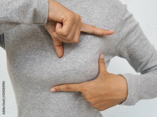 Breast cancer. woman examining breast lump on gray background health care concept. closeup photo, blurred. photo