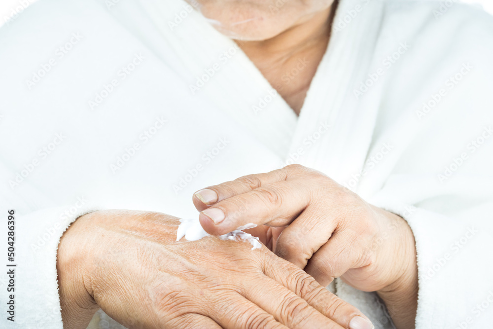 body care Senior latin woman applying cream on hands body care Senior latin woman applying cream on hands