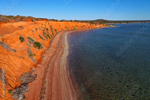 Aerial drone landscape view of coastal sea shore red cliffs and turquoise water