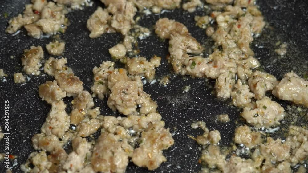 Chef stir fry minced meat in a Frying pan slow motion. Frying minced meat in a pan, close-up. Cooking taco meat at home cooking. Frying mince in frying pan on stove. High quality FullHD footage Chef stir fry minced meat in a Frying pan slow motion. Frying minced meat in a pan, close-up. Cooking taco meat at home cooking. Frying mince in frying pan on stove. High quality FullHD footage