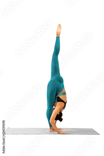 Beautiful woman in cyan sportswear does standing splits pose, Urdhva Prasarita Eka Padasana, vertical photo, isolated on white. photo