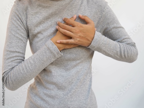 Woman heart attack symptom. closeup photo, blurred.